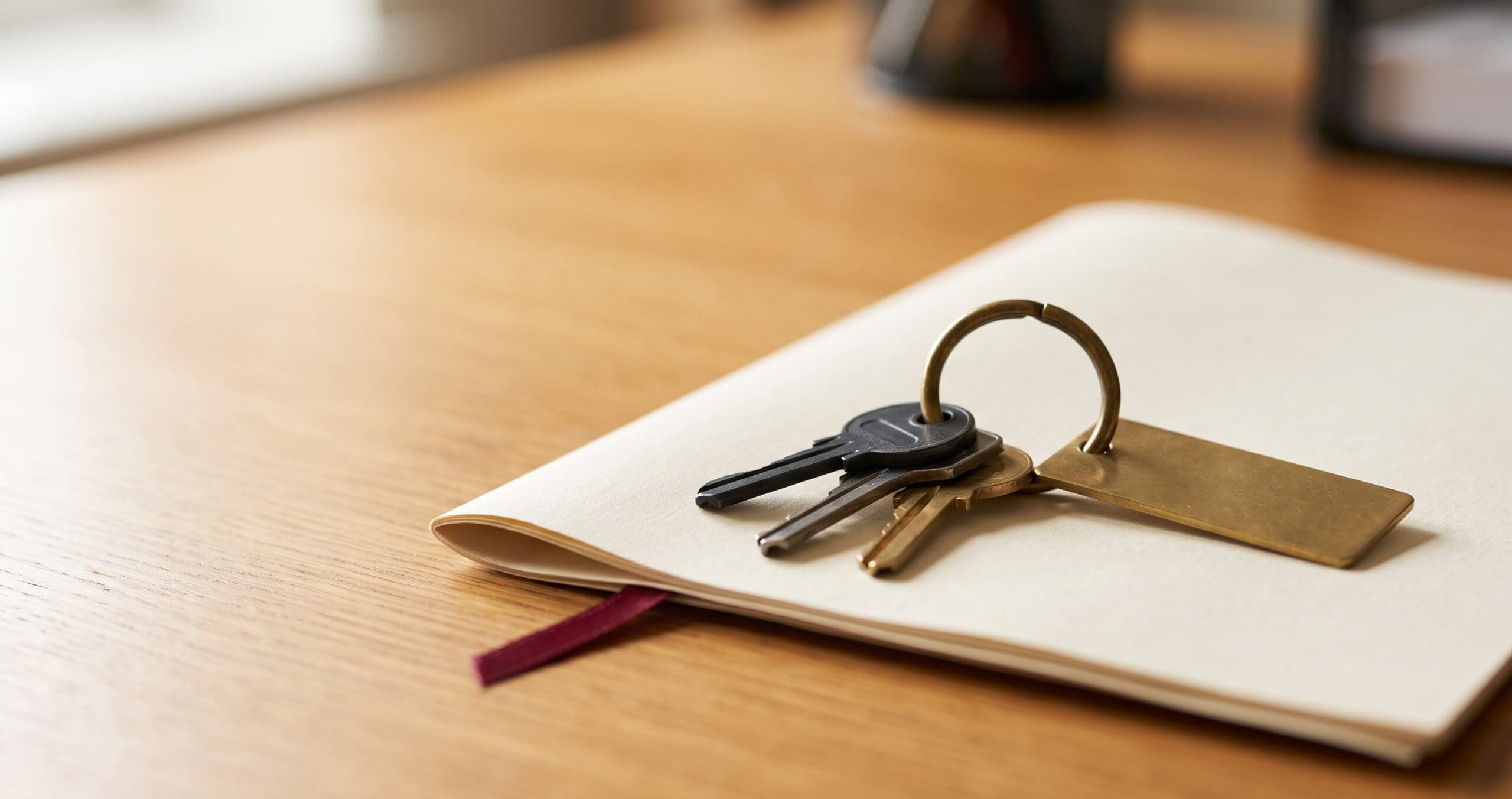 buying-tenanted-commercial-property Set of keys resting on a folded commercial lease, representing due diligence when buying a tenanted commercial property in NSW